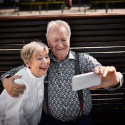 Älteres Paar macht Selfie von sich mit dem Smartphone.