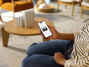 Frau guckt sich Sonoa-App auf Handy an.